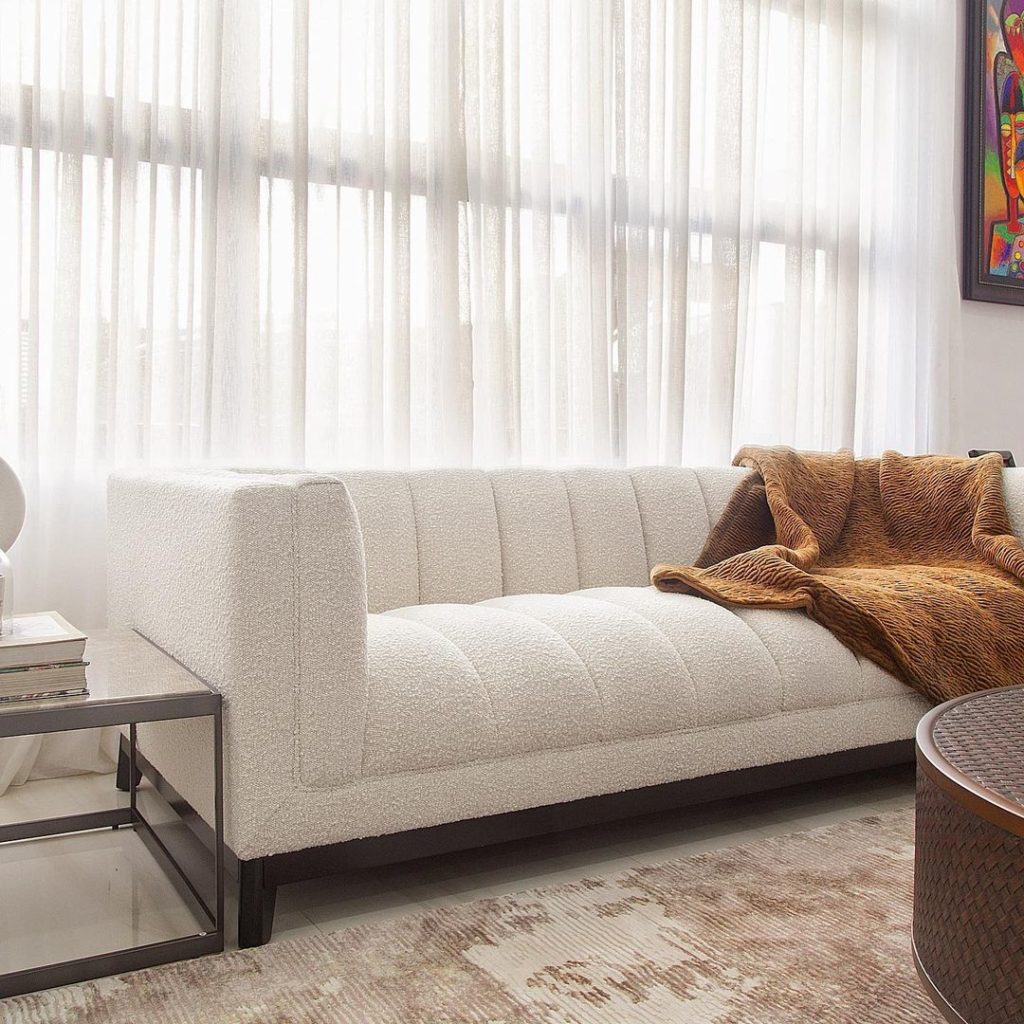 Boucle texture sofa by Eichholtz with textured brown throw in luxury Nigerian living room by Urban Living.
