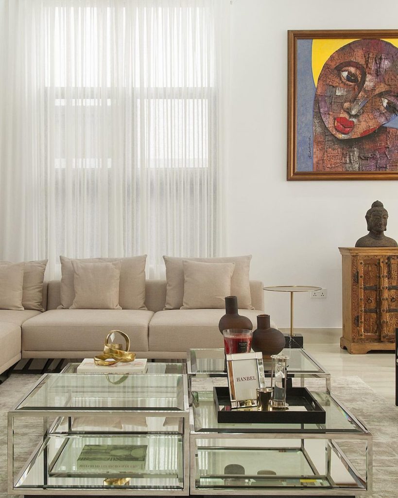 A view of the sectional sofa and glass coffee table in luxury Nigerian home by Urban Living