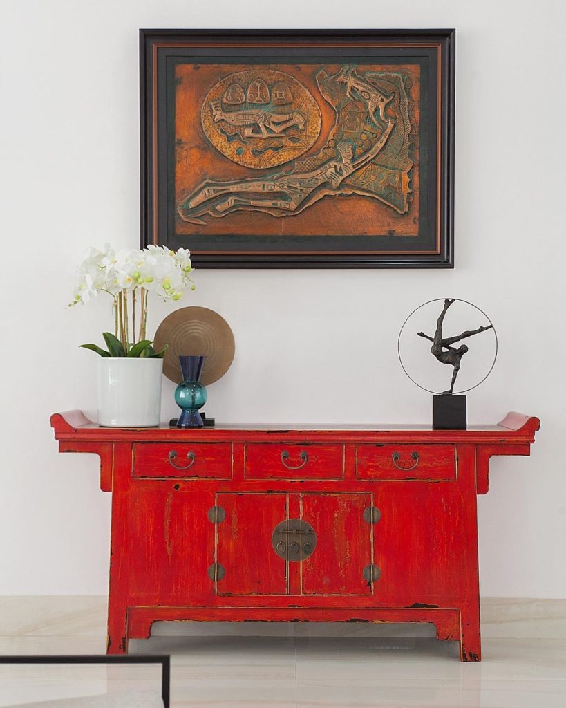 Red credenza in luxury living room decor in ikoyi home by Urban Living