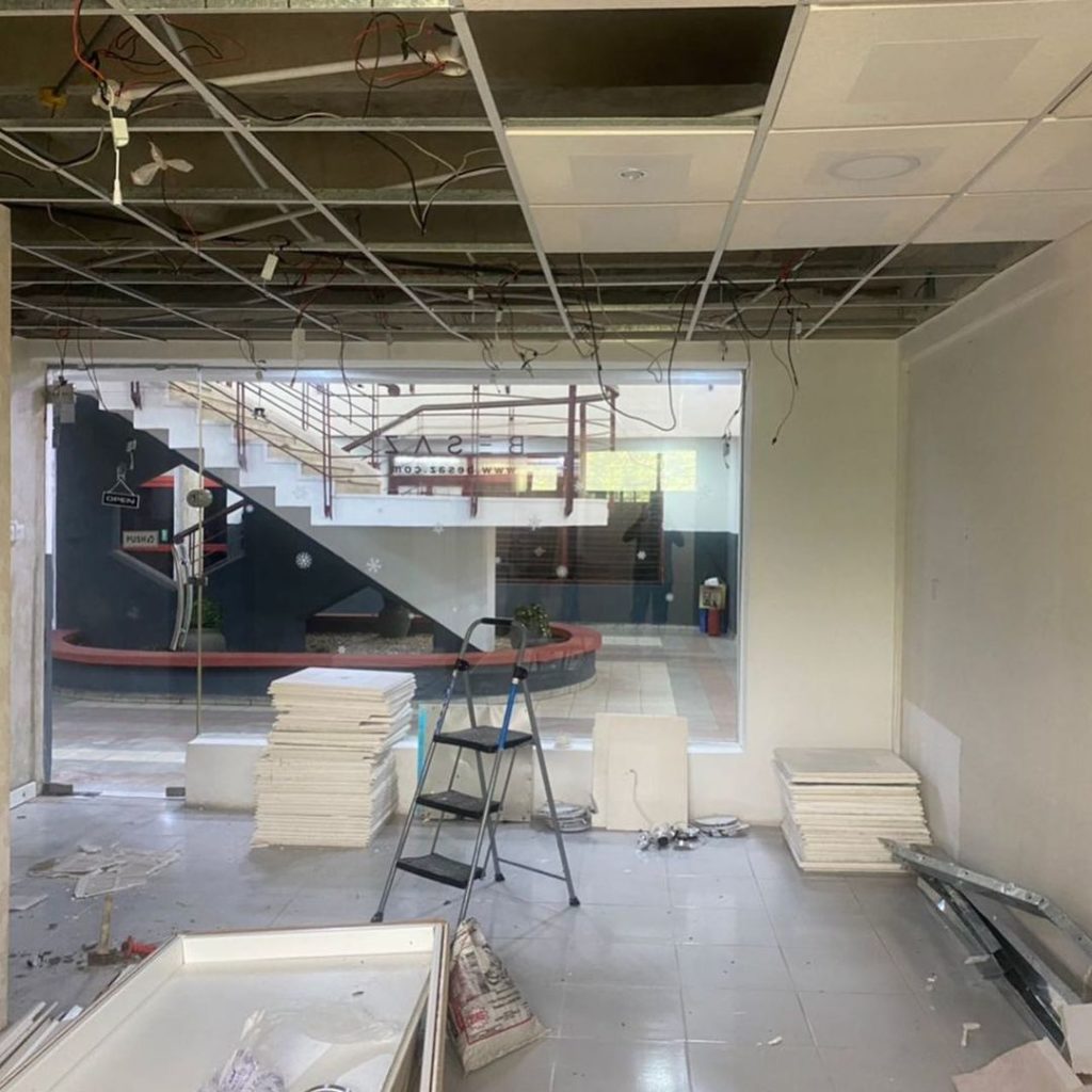Before images of Besaz fashion store showing the removal of the suspended ceiling