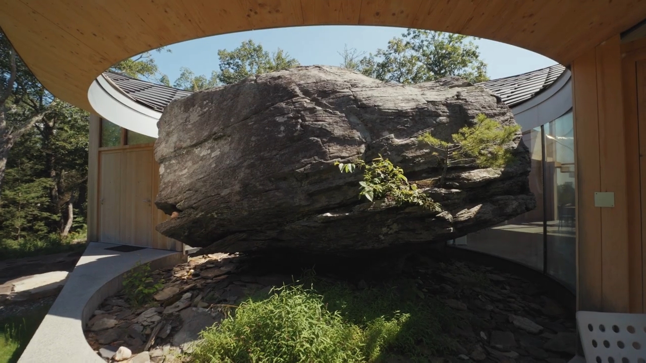 Image of the house built around a boulder by Christian Wassman