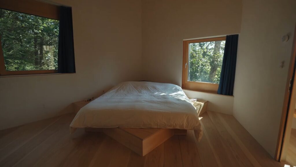 Image of the interior of a bedroom in the house built around a boulder by Christian Wassman